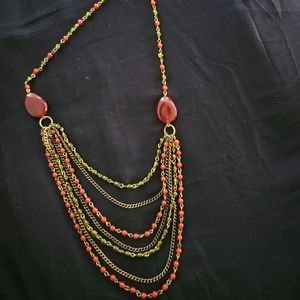 Avon multistrand necklace is goldtone and deep red
